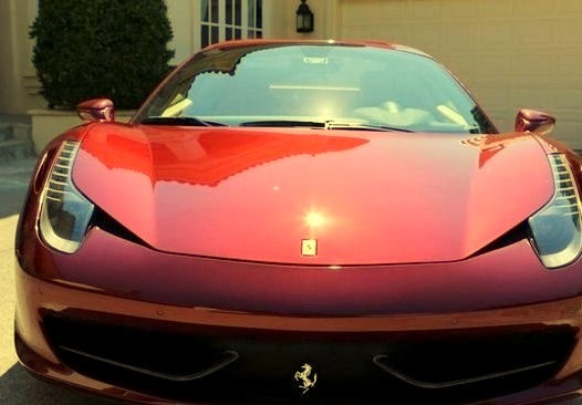 Red Ferrari Infront of a Mansionwww.DiscoverLavish.com