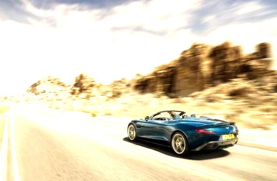 Aston Martin Convertible Speeding Down Road